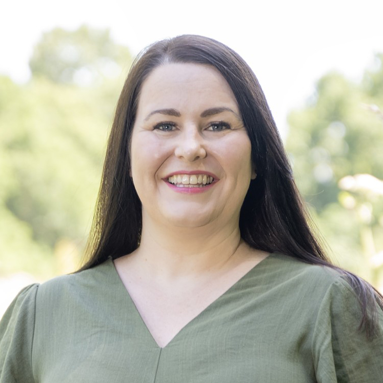 Image of a woman with her eyes closed in a forest